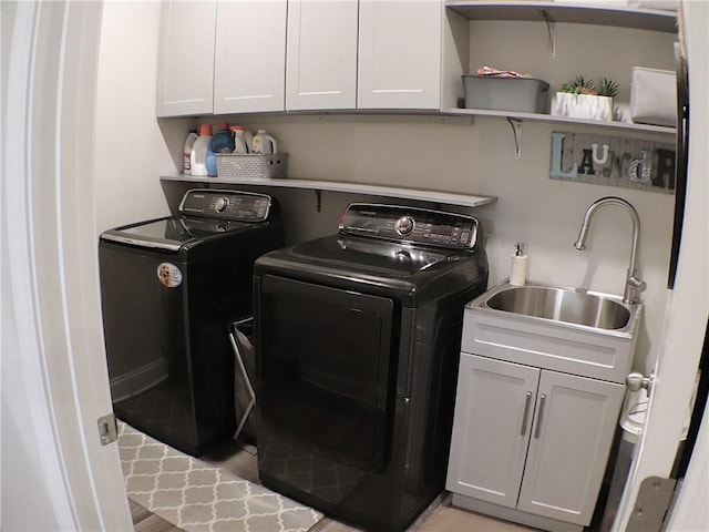 laundry room featuring a sink, cabinet space, and washing machine and clothes dryer