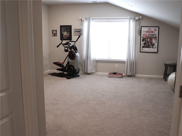 workout room featuring baseboards, vaulted ceiling, and carpet flooring