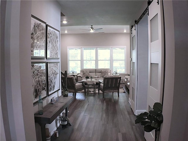 corridor featuring recessed lighting, dark wood-style floors, and a barn door