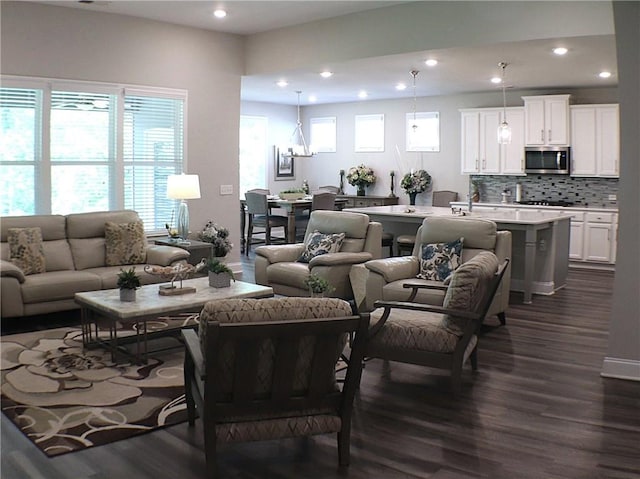 living area featuring recessed lighting, baseboards, and dark wood finished floors