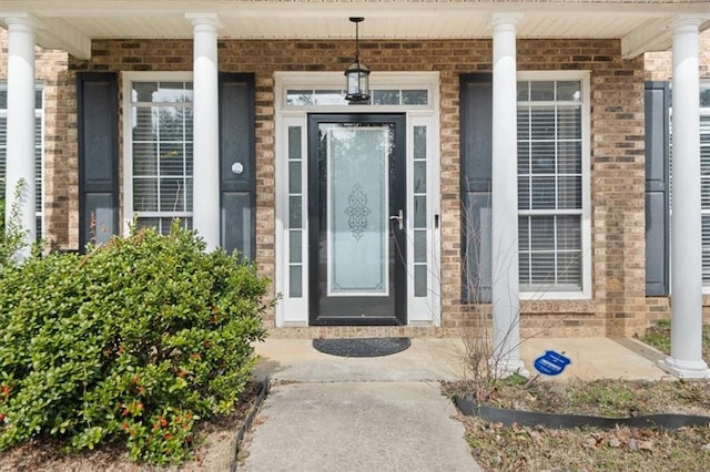 property entrance featuring brick siding