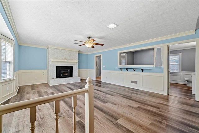 living room with hardwood / wood-style flooring, a wealth of natural light, and a textured ceiling