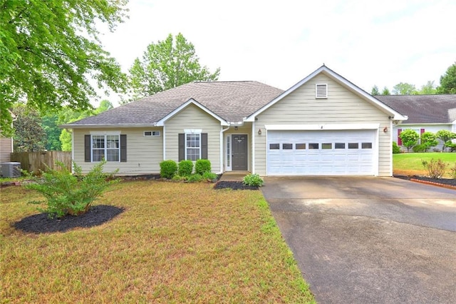 single story home with a garage, fence, a shingled roof, and aphalt driveway