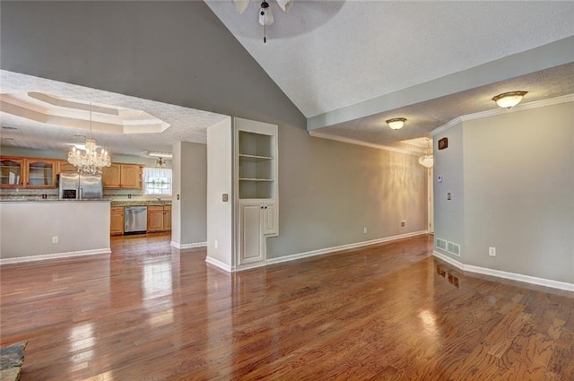 unfurnished living room featuring visible vents, baseboards, dark wood-type flooring, and ceiling fan with notable chandelier