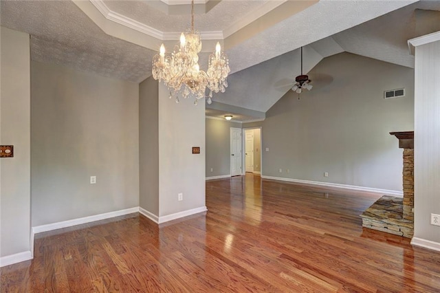unfurnished room with baseboards, ceiling fan with notable chandelier, and wood finished floors