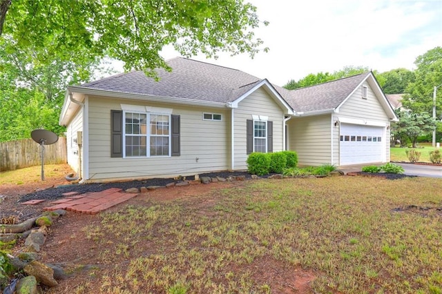 single story home with a garage, fence, a shingled roof, and aphalt driveway