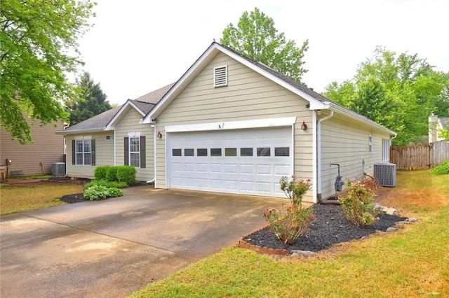 ranch-style home with fence, central air condition unit, concrete driveway, and a garage