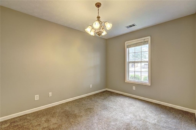 carpeted empty room with a chandelier, baseboards, and visible vents