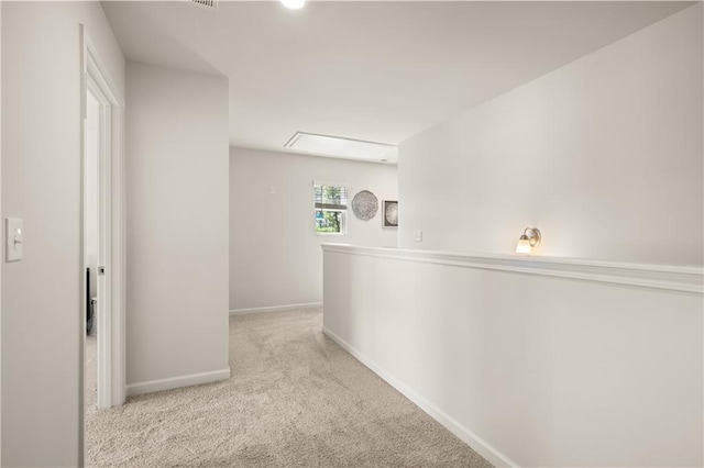 hallway featuring light colored carpet