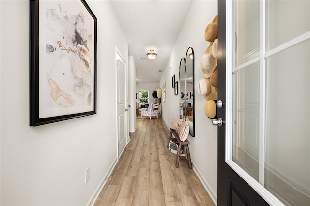 hall with light hardwood / wood-style flooring