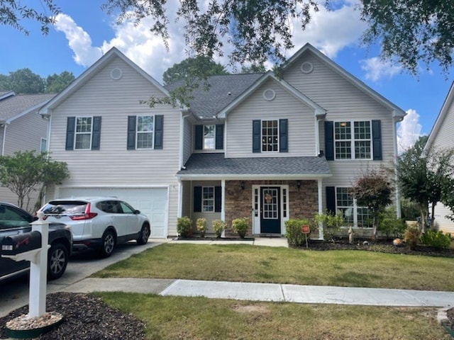 front facade with a front yard and a garage