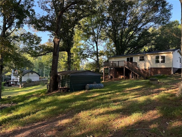 view of yard featuring an outdoor structure and a deck