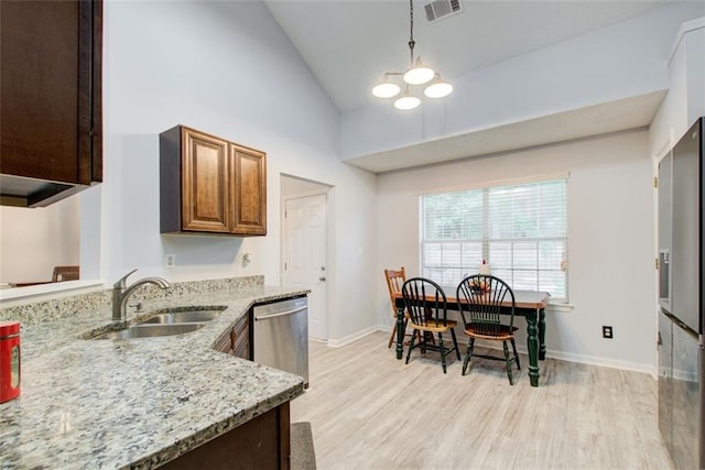 468 Berkshire Pl, Fairburn, GA 30213 - kitchen with stainless steel dishwasher, a sink, high vaulted ceiling, light wood-type flooring, and light stone countertops