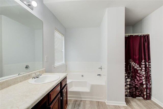 468 Berkshire Pl, Fairburn, GA 30213 - full bath featuring wood finished floors, vanity, a garden tub, and a shower with curtain
