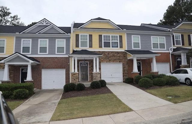 view of property with a garage and a front yard