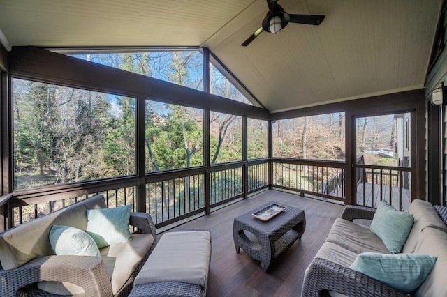 sunroom / solarium featuring lofted ceiling, plenty of natural light, and ceiling fan