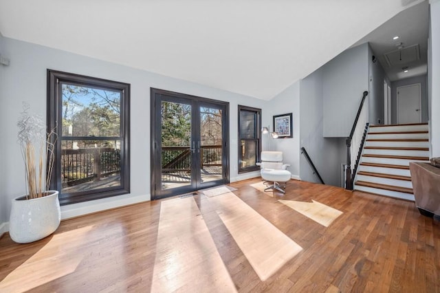 interior space featuring hardwood / wood-style flooring, vaulted ceiling, and french doors