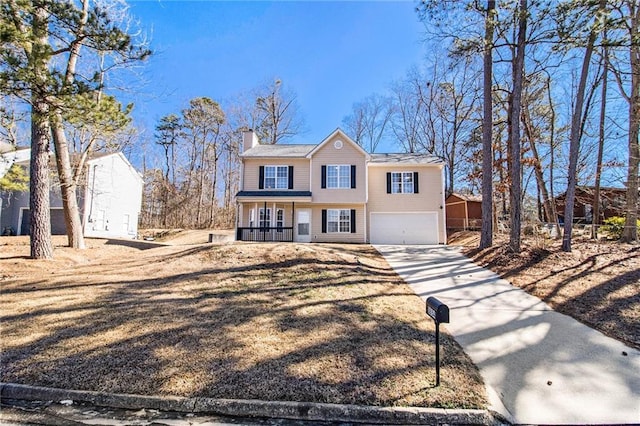 view of property with a garage and covered porch