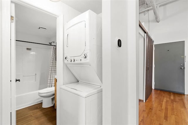 210 Walker St SW Unit 3, Atlanta, GA 30313 - washroom with estacked washer and dryer and wood finished floors