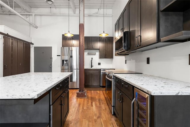 210 Walker St SW Unit 3, Atlanta, GA 30313 - kitchen with stainless steel appliances, wine cooler, light wood-style floors, a sink, and dark brown cabinets