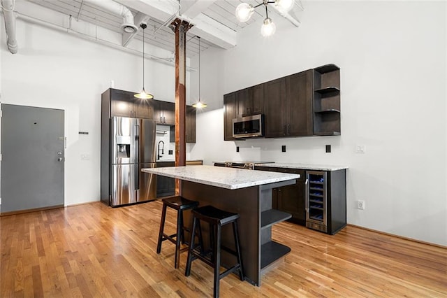 210 Walker St SW Unit 3, Atlanta, GA 30313 - kitchen with stainless steel appliances, a high ceiling, open shelves, dark brown cabinetry, and wine cooler