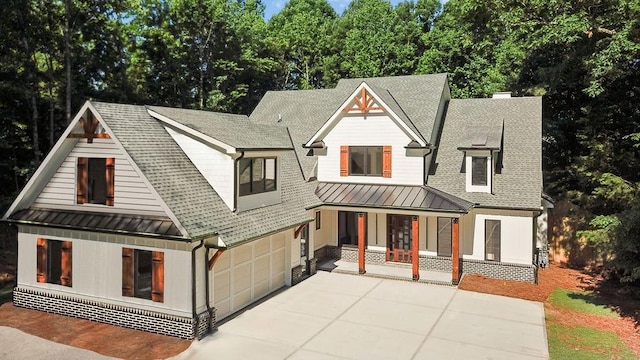 modern inspired farmhouse featuring covered porch and a garage