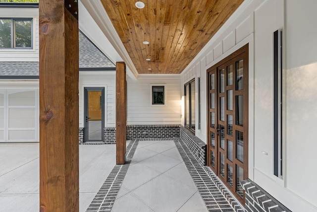 hall featuring crown molding and wood ceiling