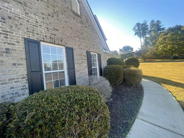 view of side of home with a lawn