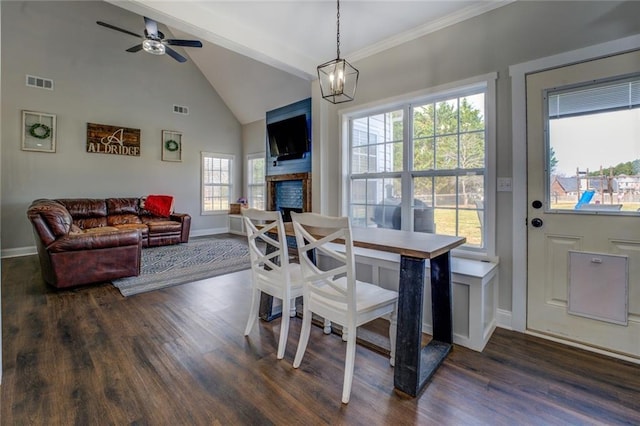 dining area featuring dark wood-style flooring, a fireplace, and visible vents