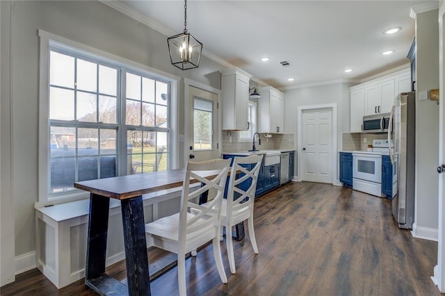 dining area featuring ornamental molding, visible vents, and dark wood finished floors