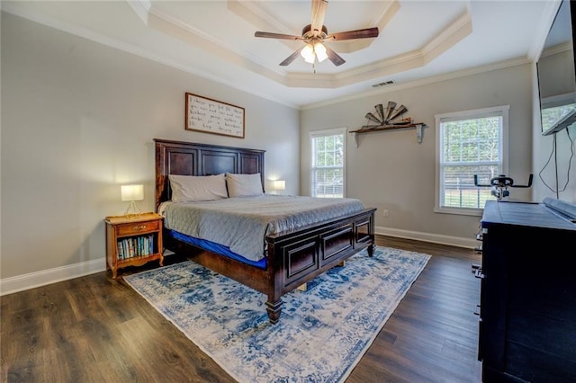 bedroom featuring multiple windows, visible vents, a raised ceiling, and dark wood-type flooring