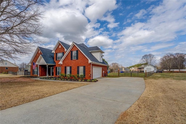 view of front of home with brick siding, an attached garage, fence, driveway, and a front lawn