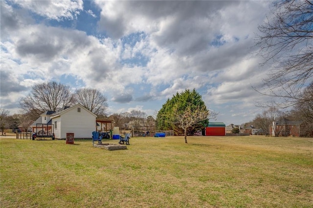 view of yard featuring a deck, a storage unit, and an outdoor structure