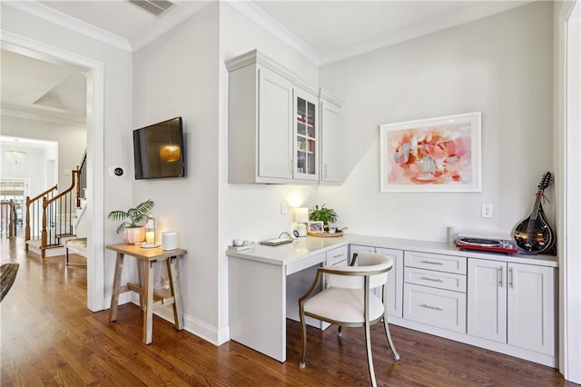 office space with ornamental molding, dark wood-style flooring, visible vents, and baseboards