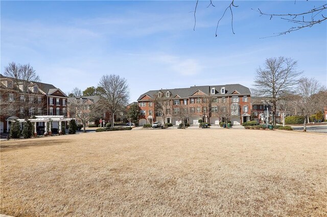 exterior space featuring a residential view and a lawn