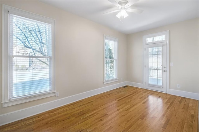 spare room with hardwood / wood-style flooring and ceiling fan