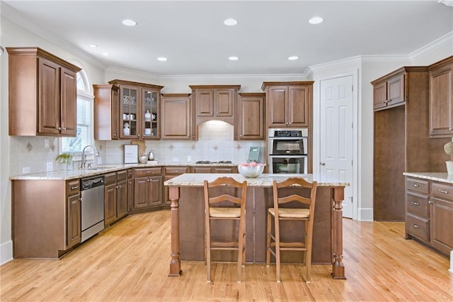 kitchen featuring light stone countertops, a center island, and appliances with stainless steel finishes