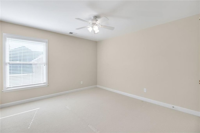 empty room featuring ceiling fan and carpet flooring