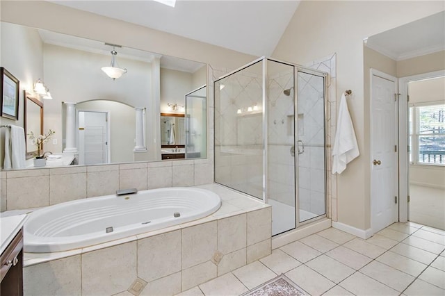 bathroom with tile patterned floors, vanity, separate shower and tub, and decorative columns