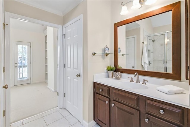 bathroom featuring crown molding, vanity, a shower with shower door, and tile patterned flooring