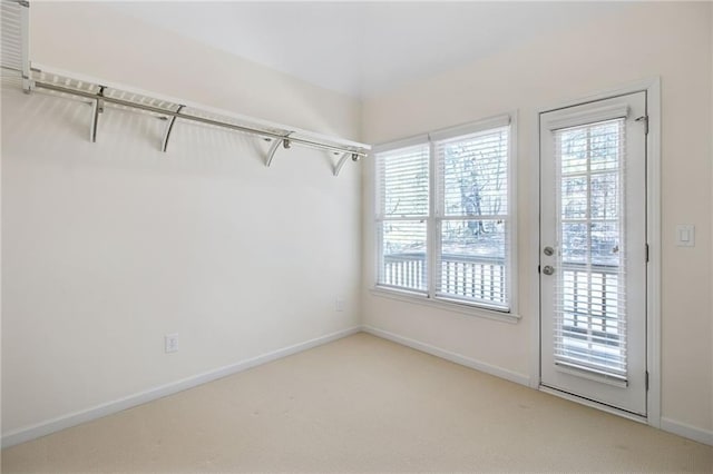 interior space with light carpet and a wealth of natural light