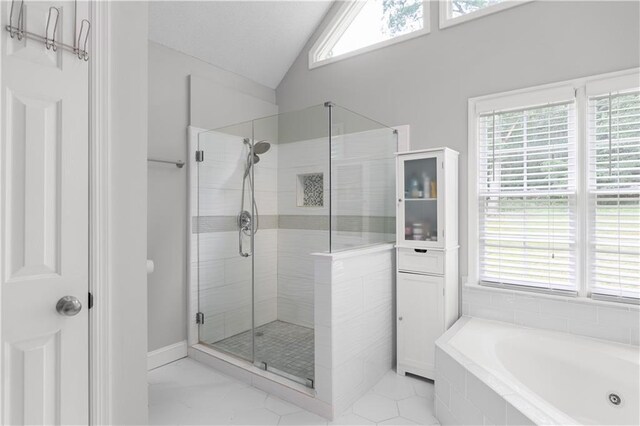 3075 Milford Chase SW, Marietta, GA 30008 - full bath featuring healthy amount of natural light, a shower stall, a garden tub, lofted ceiling, and tile patterned flooring