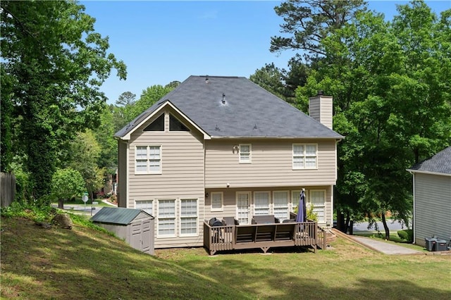 3075 Milford Chase SW, Marietta, GA 30008 - rear view of property featuring a lawn, a storage unit, a chimney, an outbuilding, and a deck
