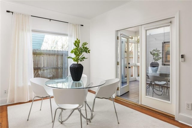 dining area with french doors and wood finished floors