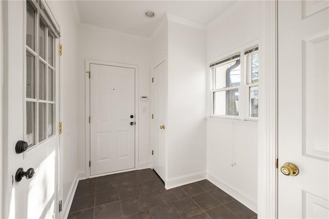 doorway featuring crown molding and baseboards