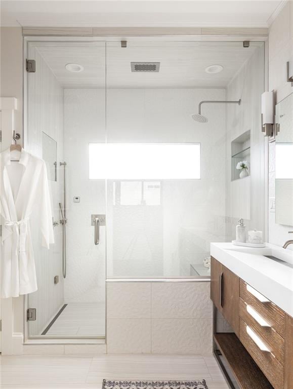 full bath with visible vents, a stall shower, and vanity