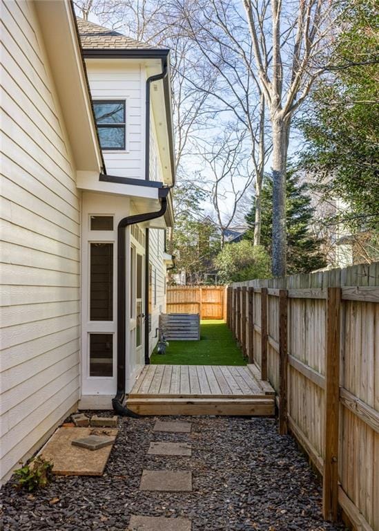 exterior space with a fenced backyard and a wooden deck