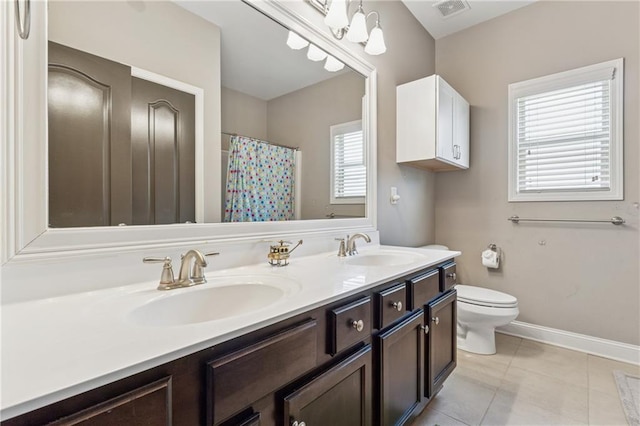 bathroom featuring toilet, tile patterned flooring, double vanity, baseboards, and a shower with shower curtain
