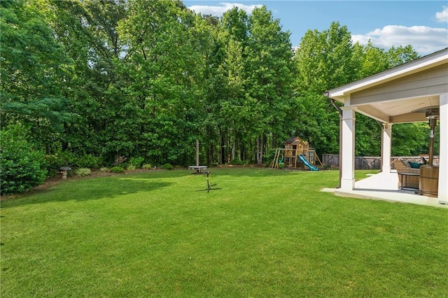 view of yard with a playground and a patio