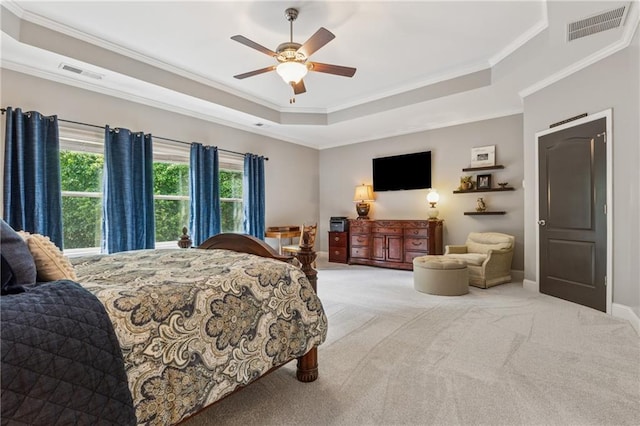 bedroom featuring ornamental molding, carpet, a raised ceiling, baseboards, and a ceiling fan